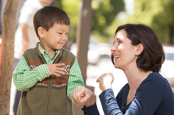 Educator and child communicating with sign language